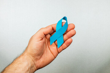 Supporting cancer awareness with a blue ribbon for detection and prevention