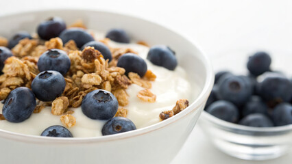 Fresh probiotic yogurt with blueberries and granola in a bowl, healthy breakfast or snack concept, nutritious food with superfood ingredients for gut health and digestion.