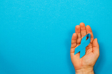 Support for cancer awareness with a blue ribbon symbolizing hope and courage