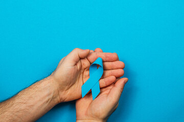 Fototapeta premium Blue ribbon symbolizes support for cancer awareness and prevention efforts