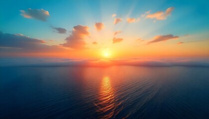 Fototapeta premium A breathtaking panoramic view captures a serene ocean at sunrise, with a color palette dominated by blues, oranges, and yellows