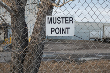 Muster point sign attched to Chain Link Fence