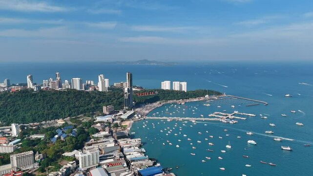Pattaya sea harbor with boats and hotels on hilly coast aerial