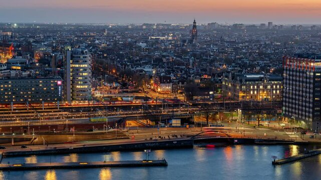 Amsterdam cityscape at night with illuminated streets, moving trains, and historical architecture. A vibrant urban skyline blending modern transit with classic Dutch charm. Timelapse shot.
