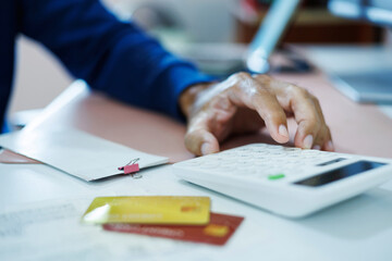 asian man calculate monthly expenses from receipt and many bill of various expenses after spending via credit card and must be pay back soon, close up shot