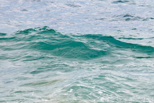 The ocean is calm and the water is a beautiful shade of blue