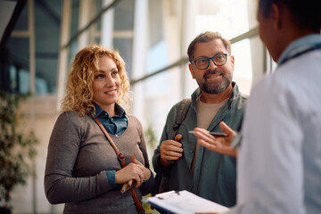 Happy couple having appointment with their doctor at clinic.
