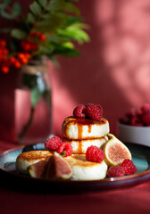 Cottage cheese pancakes with fresh raspberries on the table. Wallpaper, painting, desktop wallpaper.