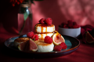 Cottage cheese pancakes with fresh raspberries on the table. Wallpaper, painting, desktop wallpaper.