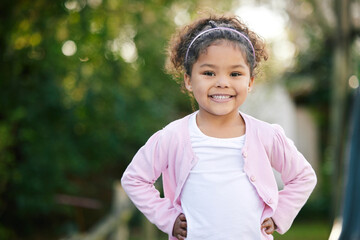 Girl, portrait and happy in playground, backyard or park for fun, joy and development as kid. Child, toddler and positive in outdoor for growth, curiosity and weekend in garden for adventure as youth