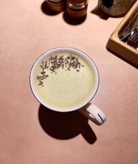 A cup with a decorated matcha drink top view