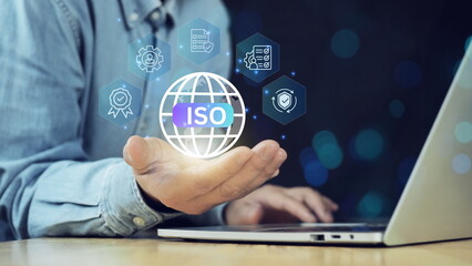 Businessman working on laptop with business ISO mark certification. Certified company certificate, Quality certificate, assurance, compliance, global standards, and International organization.