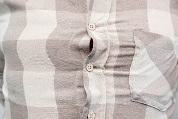 Close-up of a man in a tight shirt, shirt too small, overweight man