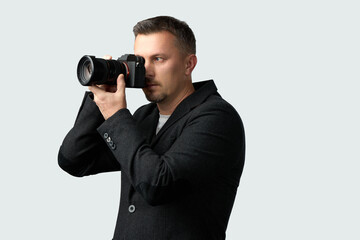 Man Taking Photo with Camera. A man using a camera, looking through the viewfinder