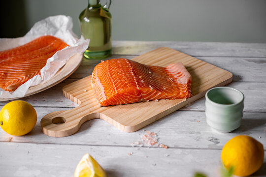 Fresh uncooked salmon fillet with pink salt and vegetable oil