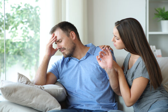 Sad man refusing partner help at home
