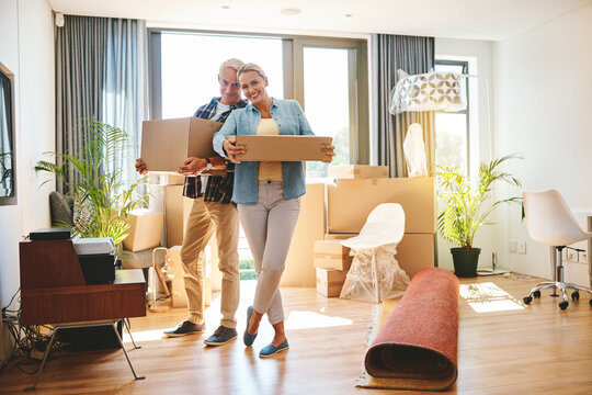 Mature, boxes and new home or moving out with living room, property or real estate support, help and excited. Happy people and carry cardboard for boxing, furniture or relocation with movers services