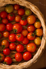 Ripe, tasty, red cherry tomatoes in a wooden basket