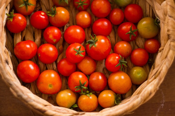 Ripe, tasty, red cherry tomatoes in a wooden basket