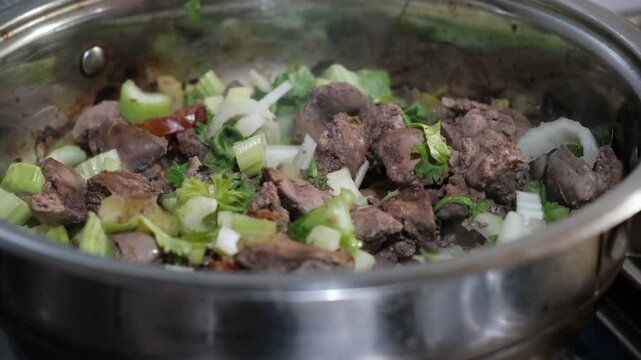 Chicken liver with fried celery, vegetables. Preparation in saucepan, with savory sauce. Healthy food. Commercial kitchen