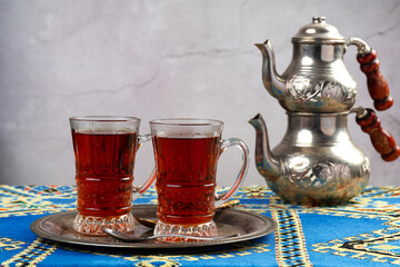 still life with traditional turkish tea in drinking glasses and silver traditional silver tea pot