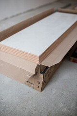 Stack of new ceramic tiles in packaging - material for wall and floor covering