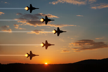 Air Force Day. Aircraft silhouettes on background of sunset. Combat flight of interceptors on a...