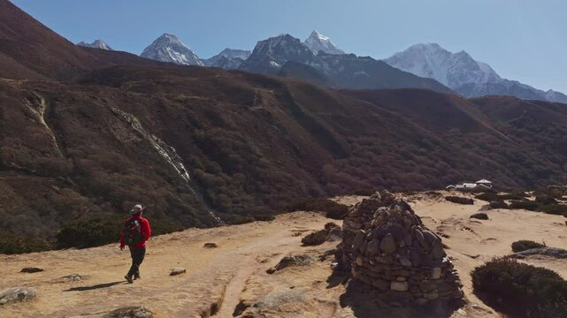 Experienced mountaineer trekking challenging Himalayan paths in the Shomare to Dingboche Route near Mount Everest, remote wilderness in Nepal's landscape