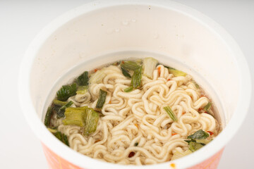 Dry instant noodles in cup isolated. Raw spaghetti in a plastic cup, fast food pasta in container