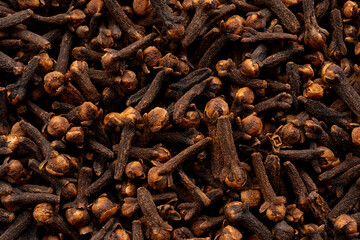 Clove spice textured background. Dry carnation spicy buds pattern, natural Indian clove condiment