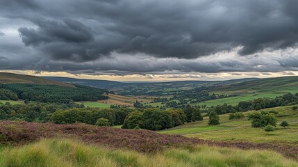 Naklejka premium Dramatic landscape under dark stormy clouds over rolling countryside views