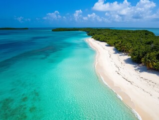 This aerial shot captures a tropical beach with crystal-clear turquoise waters crashing onto white sandy shores. Bright sunlight enhances this picturesque landscape