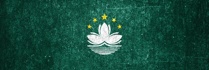 Macau state flag on a metal surface. Banner of dirty grunge Macau flag.
