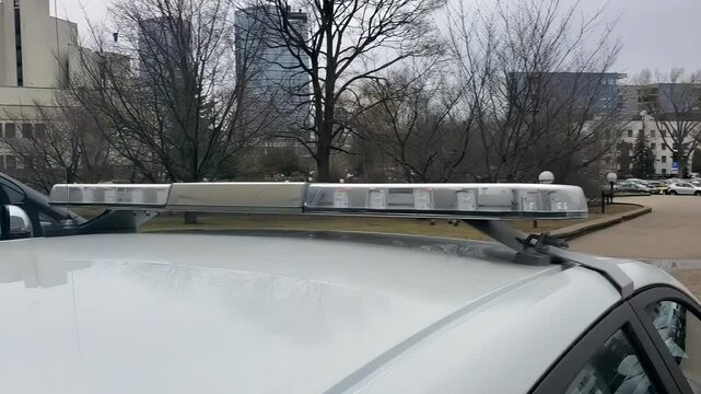 Blinking police siren lights, Police car with flashing lights representing law enforcement, urgency, and emergency response.