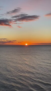 Sunrise from above at sea with the first rays and reflections of the sun