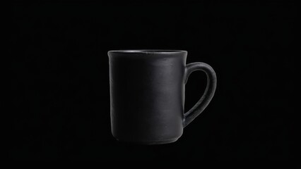 Obraz premium Black ceramic mug with curved handle and textured rim on black background, standing empty with unique design.