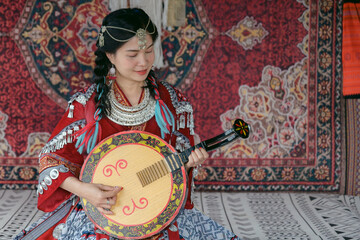 Vietnamese ethnic woman in traditional costume playing a local string instrument, surrounded by...
