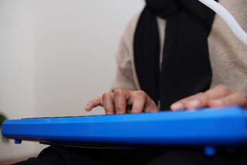 Anonymous woman playing pianica, melodica blow organ