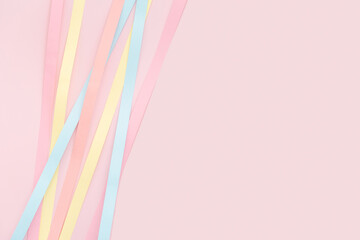 Pastel paper strips on baby pink background. Versatile Easter-themed composition perfect for backgrounds, greeting cards, social media, and seasonal marketing