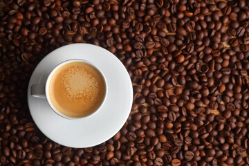 Top view of Espresso in a White Cup on Toasted Coffee Bean Background