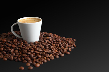 Elegant white coffee cup with espresso surrounded by dark roast coffee beans in black background with copy-space