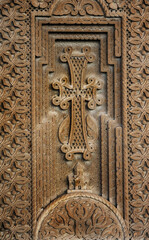 ancient stone cross with openwork relief, traditional Armenian ornate. medieval cross khachkar, carved on gravestone. symbol of ortxodox church, faith in God. memorial stelle