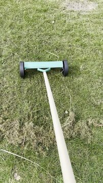 hand aerator scarifier in action spring lawn care