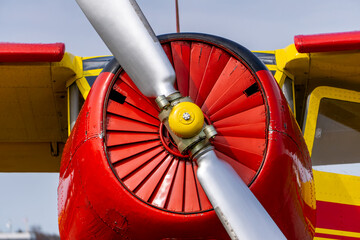 old multi-role aircraft after renovation. red and yellow aircraft of Soviet design. front view of...