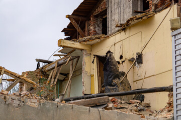 demolition of an old red brick residential building in the city center. demolition of a residential building. ruin, a falling apart building.