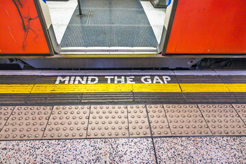 Mind the Gap Warning on London Underground Train Platform with Open Door