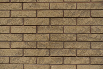 beige split face brick veneer wall with running bond layout texture