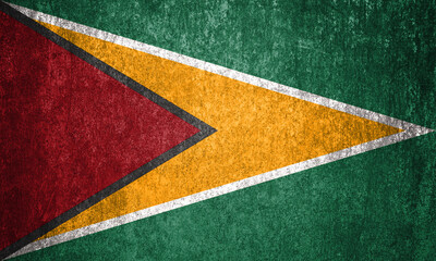 Guyana state flag on a metal surface. Dirty grunge Guyana flag.