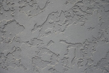 Close shot of gray wall with troweled dash stucco finish