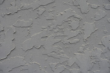Macro of gray wall with troweled dash stucco finish